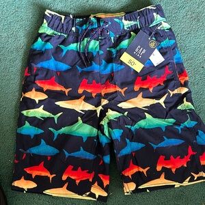 NWT boys size Medium (8) bathing suit. Dark blue with bright colorful sharks.